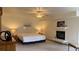 Main bedroom with neutral colors, a fireplace, and an elegant ceiling fan at 19850 Indian Summer Ln, Monument, CO 80132