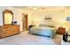 Main bedroom with plush carpet, ample lighting, and ensuite bathroom access at 19850 Indian Summer Ln, Monument, CO 80132