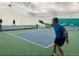 Indoor pickleball court where a player is actively playing while others are in the background at 19850 Indian Summer Ln, Monument, CO 80132