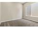 Bedroom featuring soft carpet, neutral color, and a window providing natural light and neighborhood views at 5909 S Platte Canyon Dr, Littleton, CO 80123