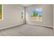 Bright bedroom with new carpet, base trim, and windows providing plenty of natural light and neighborhood views at 5909 S Platte Canyon Dr, Littleton, CO 80123