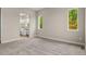 Spacious bedroom featuring soft carpet, natural light, and an open doorway to a connecting bathroom at 5909 S Platte Canyon Dr, Littleton, CO 80123