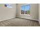 Well-lit bedroom with soft carpet and a large window offering pleasant views of the street at 5909 S Platte Canyon Dr, Littleton, CO 80123
