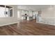 Open kitchen and living area with stainless appliances, an island, hardwood floors, and an abundance of natural light at 5909 S Platte Canyon Dr, Littleton, CO 80123