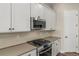 Gourmet kitchen featuring stainless appliances, sleek countertops, backsplash, and abundant cabinet space at 5909 S Platte Canyon Dr, Littleton, CO 80123