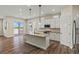 Modern kitchen with stainless steel appliances, gray countertops, hardwood floors, and pendant lighting over the island at 5909 S Platte Canyon Dr, Littleton, CO 80123