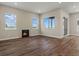 Bright and airy living area featuring a fireplace, hardwood floors, and multiple windows for lots of natural light at 5909 S Platte Canyon Dr, Littleton, CO 80123