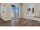 Bright living area with hardwood floors, a sliding glass door to the patio, and bright windows at 5909 S Platte Canyon Dr, Littleton, CO 80123