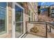 Exterior view of a stone-clad building from the balcony with metal guardrails at 13598 Via Varra # 105, Broomfield, CO 80020