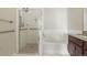 Spacious bathroom featuring a separate shower and tub, complemented by sleek fixtures and tiled walls at 13598 Via Varra # 105, Broomfield, CO 80020