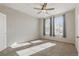 Bright bedroom with carpet, fan, and windows providing ample natural light at 13598 Via Varra # 105, Broomfield, CO 80020