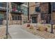 Inviting condo building entrance with a walkway and beautifully landscaped exterior details at 13598 Via Varra # 105, Broomfield, CO 80020