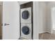 Stacked washer and dryer are efficiently tucked away in a closet, perfect for space-saving convenience at 13598 Via Varra # 105, Broomfield, CO 80020