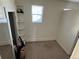 Small carpeted room with built-in shelving and a window at 2469 Ames St, Edgewater, CO 80214