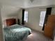 Cozy bedroom with two windows providing natural light and a fluffy blue comforter at 2469 Ames St, Edgewater, CO 80214