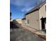 Side view of a home and detached garage, with driveway at 2469 Ames St, Edgewater, CO 80214