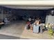A cluttered two car garage with various items stored inside at 2469 Ames St, Edgewater, CO 80214