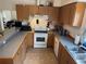 Cozy kitchen featuring wood cabinets, modern appliances, and a convenient layout at 2469 Ames St, Edgewater, CO 80214