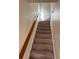 Carpeted staircase with wooden railing leading to the upper level of the home at 2469 Ames St, Edgewater, CO 80214