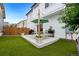 Outdoor oasis featuring a patio with picnic table, turf lawn, string lights, and landscaped borders at 10254 Worchester St, Commerce City, CO 80022