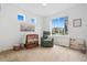 Bright Bedroom with a crib, comfortable chair, and natural light from a large window at 10254 Worchester St, Commerce City, CO 80022