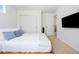 Clean bedroom features a neutral color scheme, closet, and a television at 10254 Worchester St, Commerce City, CO 80022