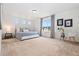 Spacious bedroom with large window, plush carpet, and side table decor at 10254 Worchester St, Commerce City, CO 80022