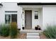 Close-up view of the front entrance, showcasing a gray door and decorative plants at 10254 Worchester St, Commerce City, CO 80022