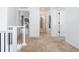 Second floor hallway with carpet leading to several bedrooms and bathrooms at 10254 Worchester St, Commerce City, CO 80022