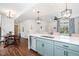Bright kitchen features an island with seating, stainless steel appliances, and stylish lighting at 10254 Worchester St, Commerce City, CO 80022