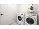 Functional laundry room equipped with a modern washer and dryer set and storage at 10254 Worchester St, Commerce City, CO 80022