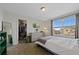Bright bedroom featuring a large window, closet, dresser, and a television for comfortable living at 24432 E Tennessee Pl, Aurora, CO 80018