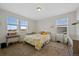 Bedroom with three windows, carpet, ceiling fan, and space for a desk and dresser at 24432 E Tennessee Pl, Aurora, CO 80018