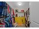 Bright walk-in closet featuring built-in shelving, hanging racks, and a stylish yellow dresser for ample storage at 24432 E Tennessee Pl, Aurora, CO 80018