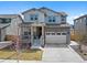 Charming two-story home featuring stone accents, a two-car garage, and a welcoming front porch at 24432 E Tennessee Pl, Aurora, CO 80018
