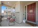 Inviting front porch with chairs, a welcome mat, and a charming front door at 24432 E Tennessee Pl, Aurora, CO 80018