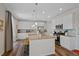 Kitchen features white cabinets, granite counters, a large island with seating and stainless steel appliances at 24432 E Tennessee Pl, Aurora, CO 80018