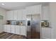 Kitchen features stainless steel refrigerator complemented by bright white cabinetry and countertops at 24432 E Tennessee Pl, Aurora, CO 80018