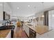 Bright kitchen featuring stainless appliances, granite counters, and large island open to the living room at 24432 E Tennessee Pl, Aurora, CO 80018