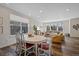 Open-concept living room and dining area with hardwood floors and ample natural light at 24432 E Tennessee Pl, Aurora, CO 80018