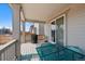 Cozy covered porch featuring outdoor seating, a grill, and seamless access to the home's interior at 24432 E Tennessee Pl, Aurora, CO 80018