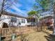 Back of home features a fenced yard and covered porch and stairs to backyard at 6 Woodland Cir, Highlands Ranch, CO 80126