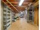 Unfinished basement area with shelving and exposed ceiling offers potential for customization and extra storage space at 6 Woodland Cir, Highlands Ranch, CO 80126