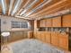 Unfinished basement with wooden cabinets, ready to be transformed into your dream space at 6 Woodland Cir, Highlands Ranch, CO 80126