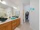 Beautiful bathroom features dual vessel sinks, wood cabinetry, and a large mirror at 6 Woodland Cir, Highlands Ranch, CO 80126