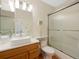 Bathroom with a vessel sink, white marble countertop, and a glass shower door at 6 Woodland Cir, Highlands Ranch, CO 80126