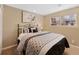 Serene bedroom with a comfortable bed, soft lighting, and a view of the outdoors at 6 Woodland Cir, Highlands Ranch, CO 80126