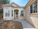 Inviting front entrance with neutral tones, large bay window and a well-maintained walkway and small garden at 6 Woodland Cir, Highlands Ranch, CO 80126