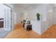 Bright hallway with hardwood floors and a cozy bench for relaxing at 6 Woodland Cir, Highlands Ranch, CO 80126