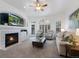 Comfortable living room with fireplace, plush seating, neutral tones, and lots of natural light at 6 Woodland Cir, Highlands Ranch, CO 80126